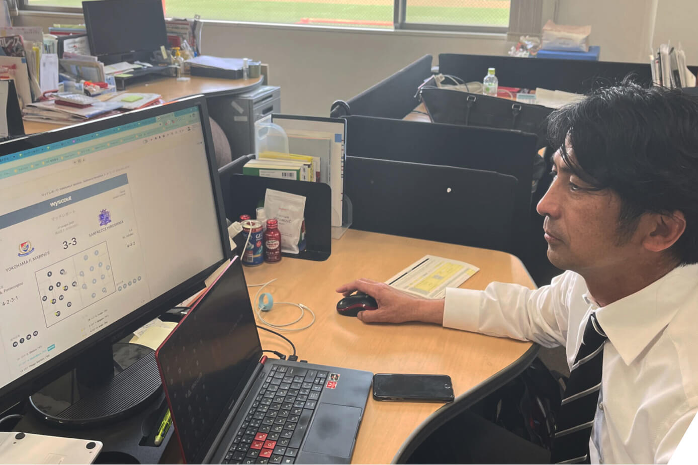 Urawa Reds Technical Director Tsutomu Nishino using the Wyscout platform on a computer